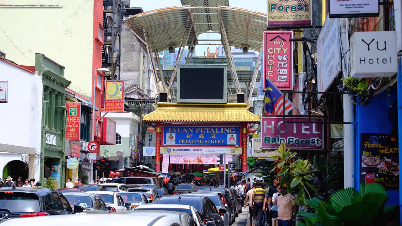 Urban street view of Jalan Petaling in Chinatown with hotels, restaurants, shops in capital city of Kuala Lumpur, Malaysia