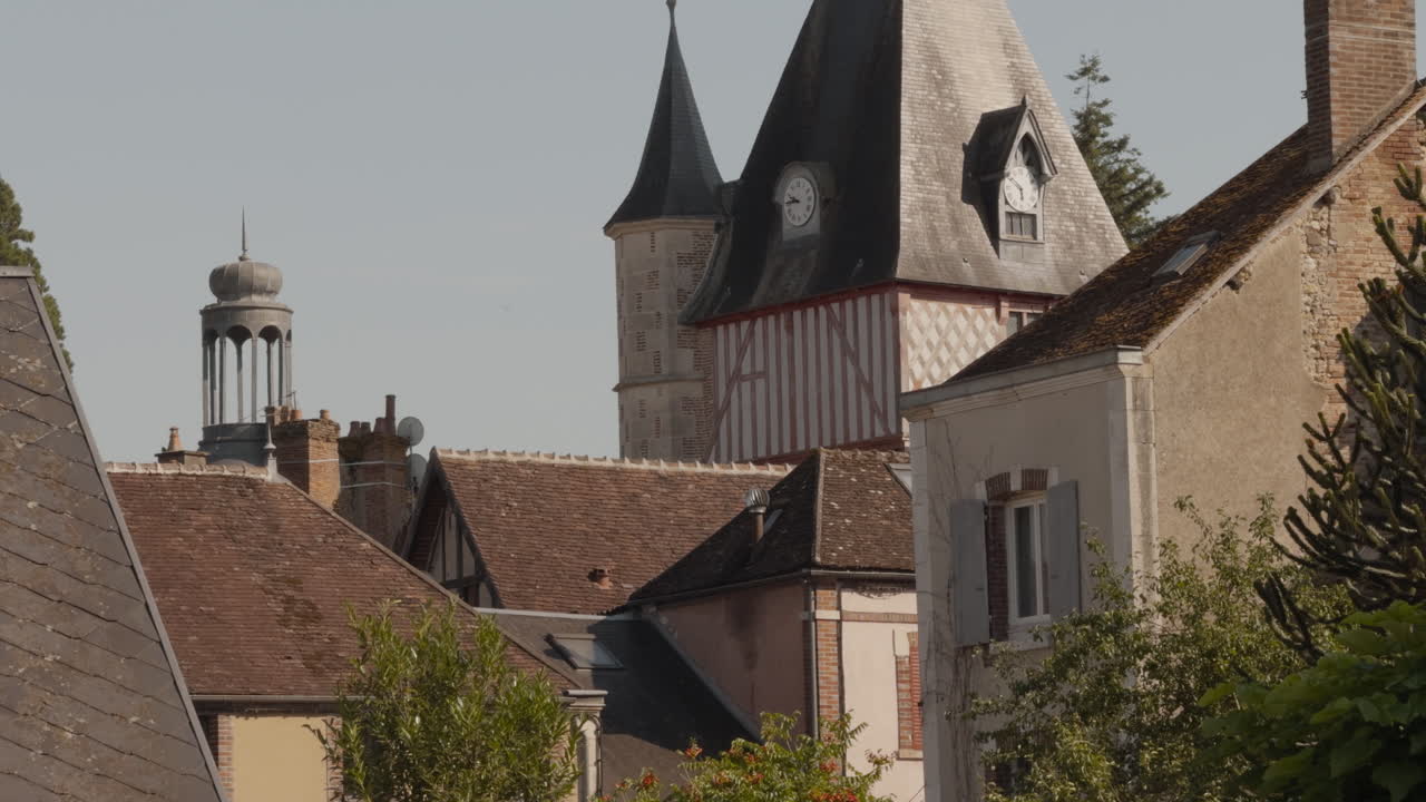 Revealing shot of Belfry at Saint-Fargeau town in France during noon