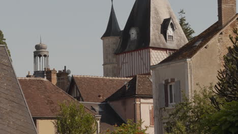 Revealing shot of Belfry at Saint-Fargeau town in France during noon