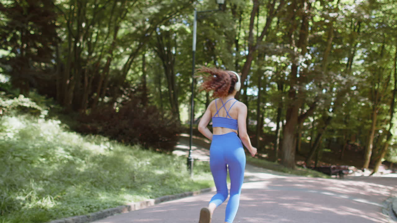 Athletic fitness sport motivated runner girl training marathon run starting race showing thumb up