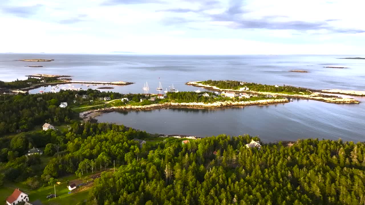 Aerial view of Matinicus Island, Maine, featuring evergreen forest, a small village, and the remote North Atlantic coastline.