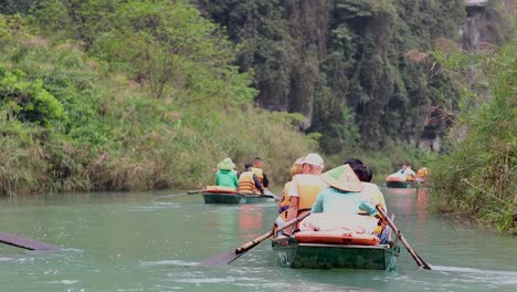 rowboats navigating lush, scenic river in vietnam