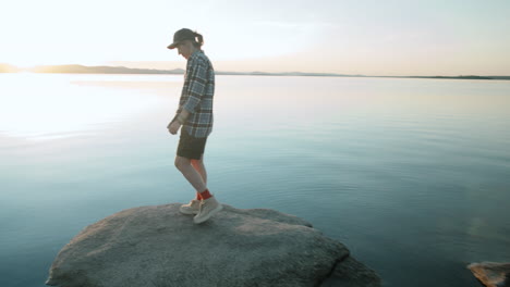 Woman-Watching-Sunset-from-Rocky-Lakeshore