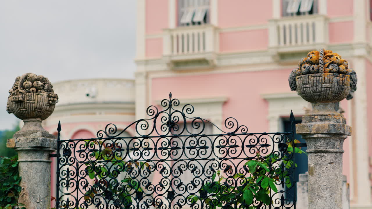 Close up of a decorative stone pillar in the courtyard of Villa Ephrussi de Rothschild with a blurred view on the background