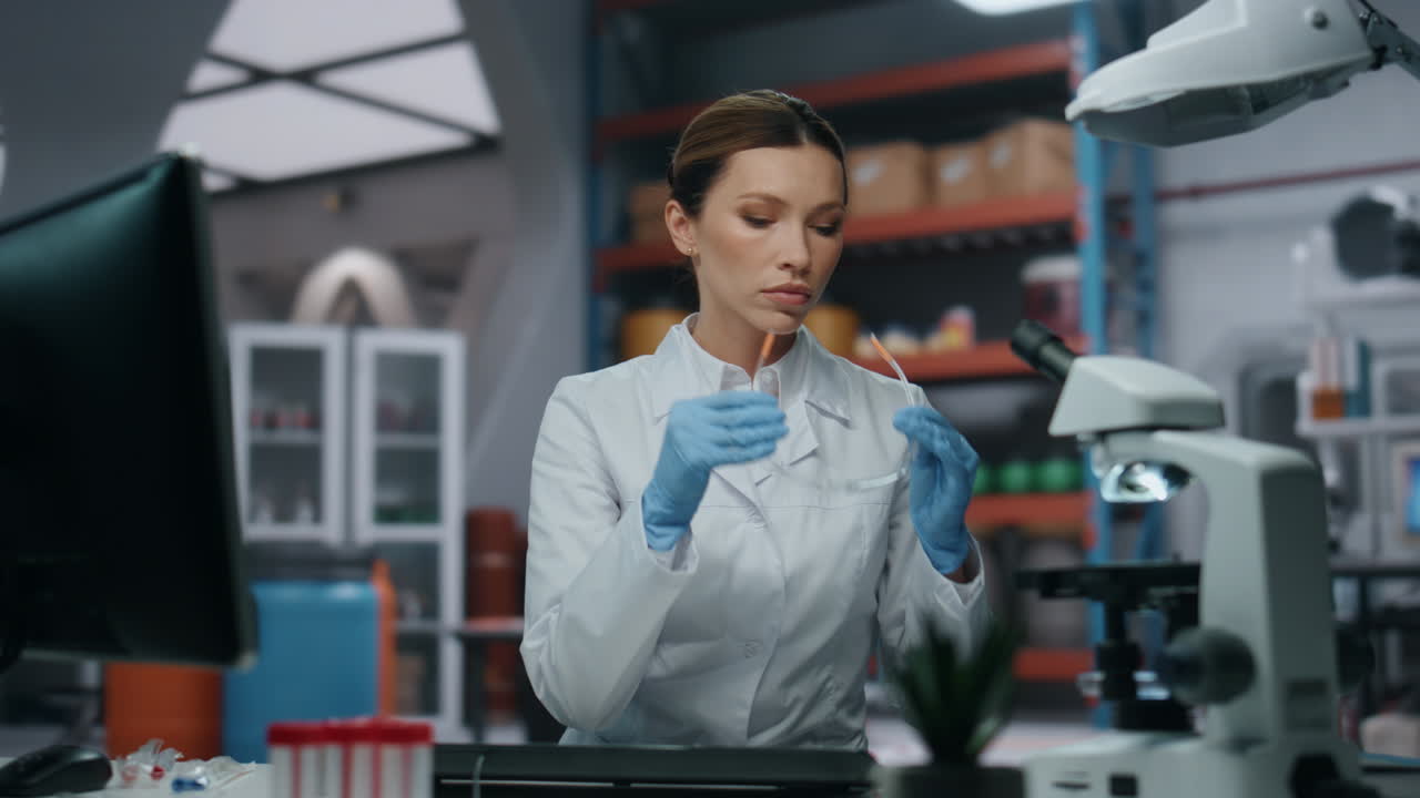 Medical researcher looking computer wearing glasses closeup. Woman scientist