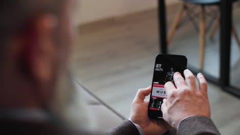 back view of a man using smartphone