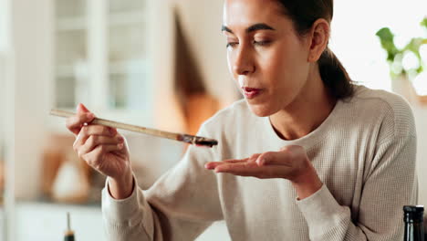 woman tasting food in kitchen