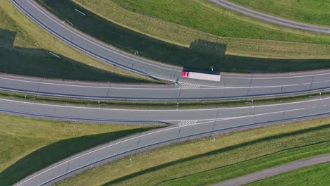 static overhead aerial of traffic on highway ramps in sunlight