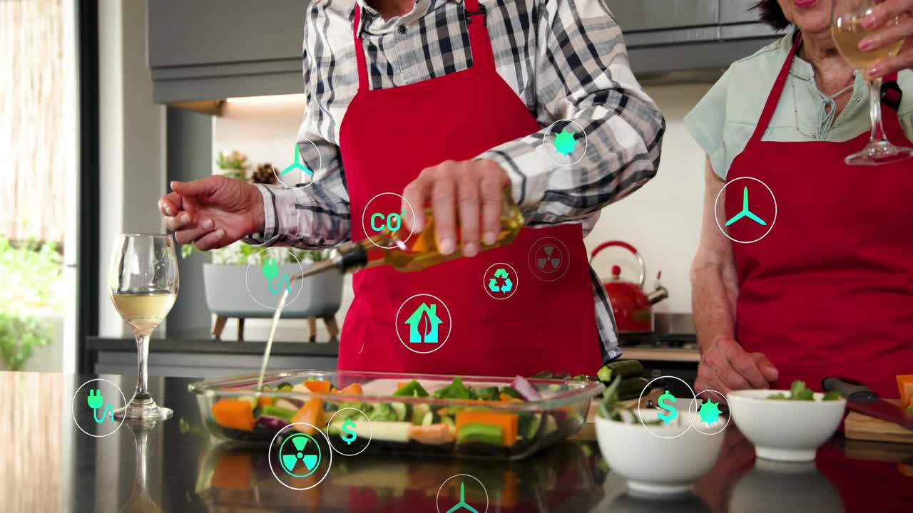 Senior couple chopping zucchini causing floating eco icons while cooking dish, adding herbs and oil