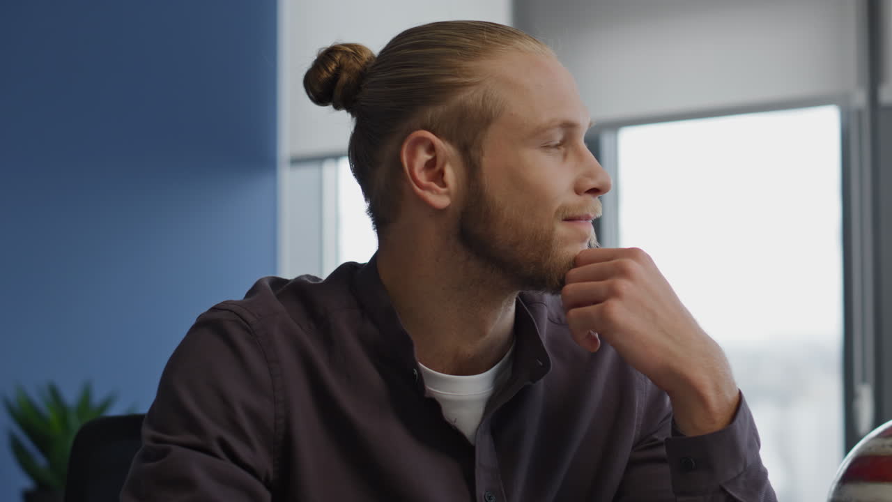 Thinking man working office portrait. Focused freelancer watching window closeup