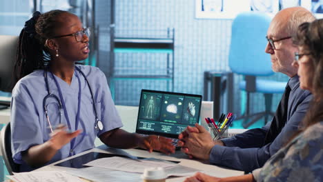 vertical video medical assistant consulting couple of patients about test results and mri scans
