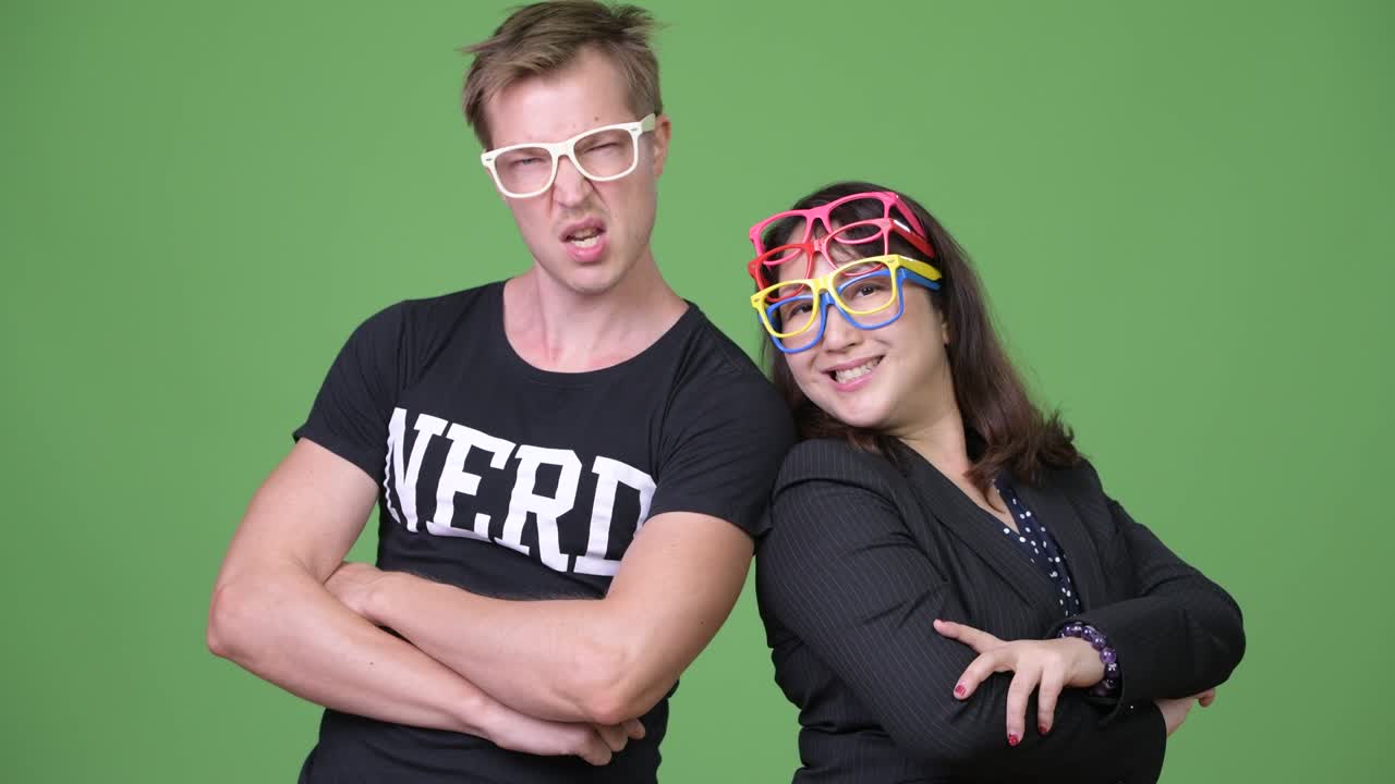 Mature Asian businesswoman and young Scandinavian nerd man together