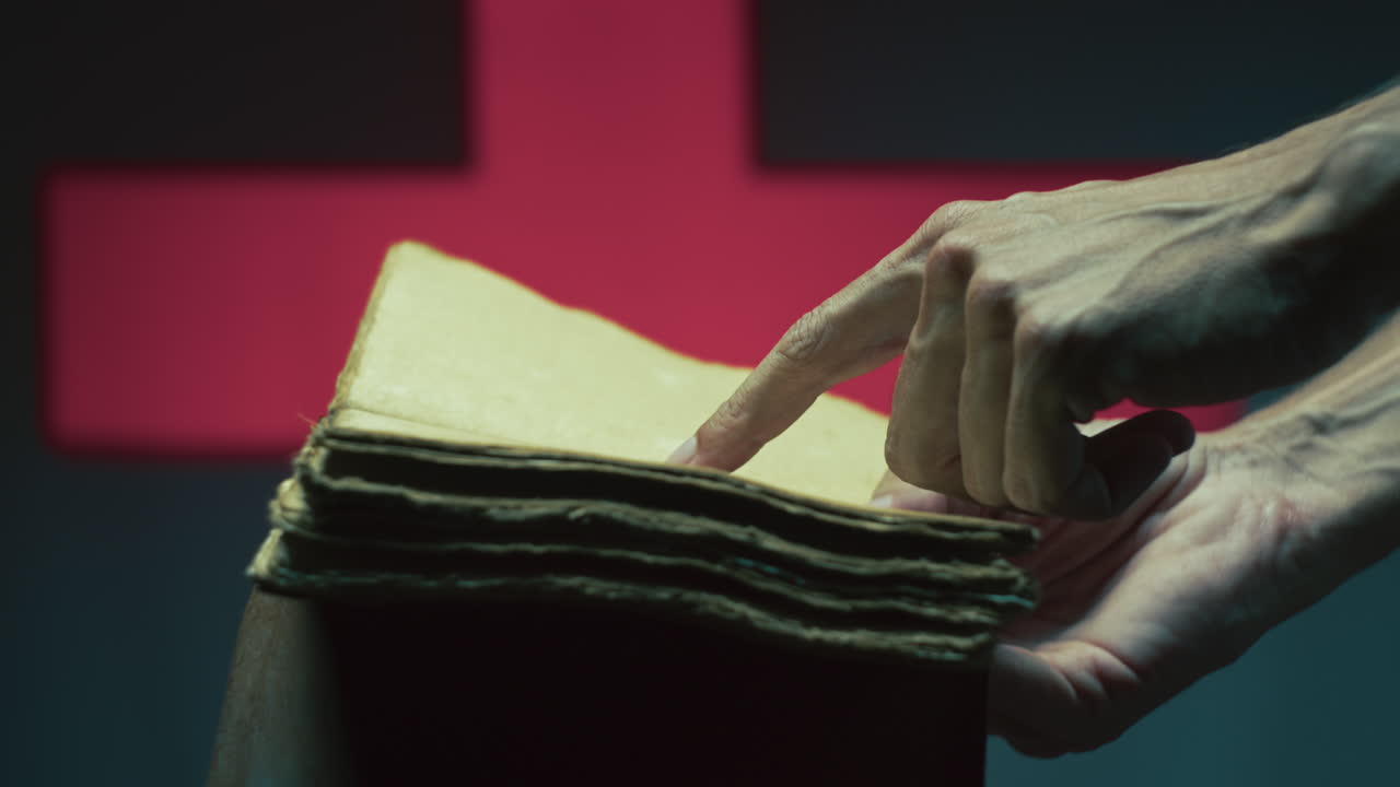 Person's hand reads an empty book on Halloween night