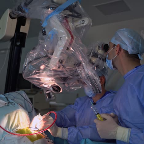 high-precise equipment being used by neurosurgeons while operating. doctor checking the running of operation in the microscope