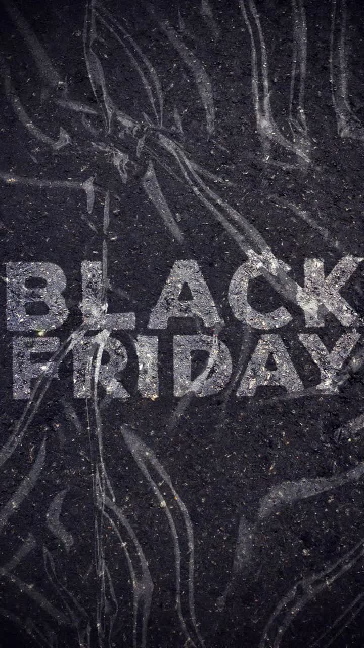 Black Friday -teksti aaltoilevalla muovipeitteellä tummalla pinnalla