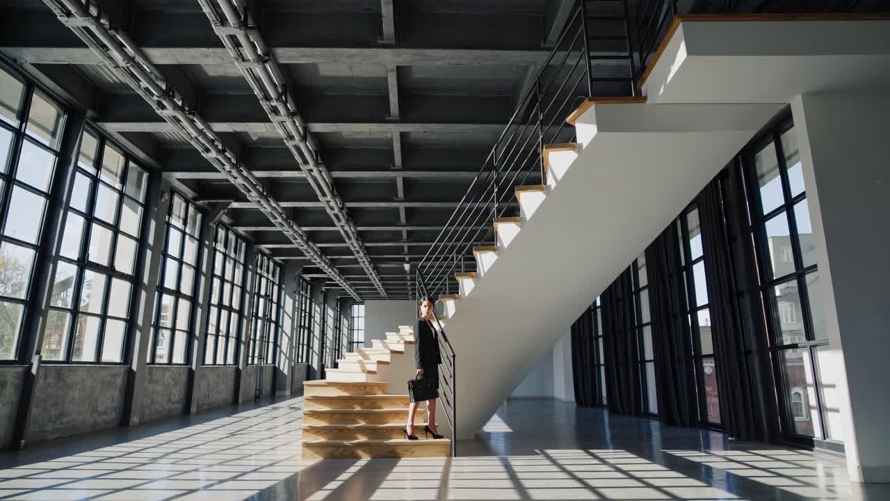 Business woman on stairs in modern office space