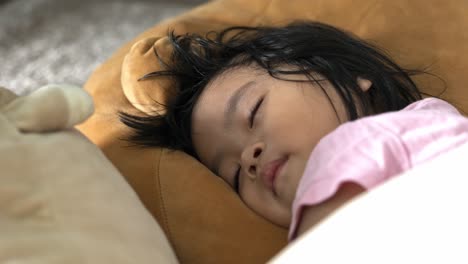 beautiful 2 year old malaysian girl sleeping peacefully - family childhood and innocence concepts