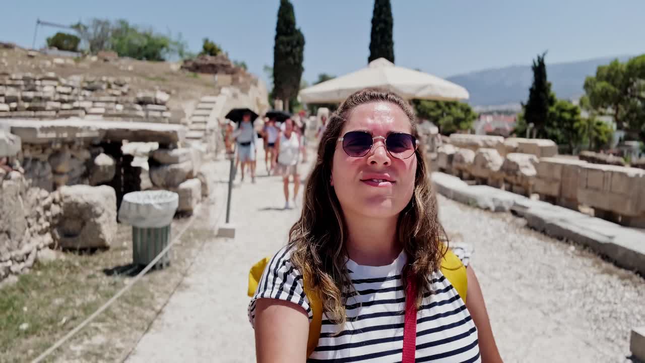 Candid Woman Walking Among Historic Ruins in Athens, Greece