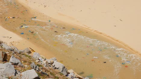 Ocean-pollution-and-plastic-waste-on-the-beach-in-Ninh-Thuan-province,-Vietnam