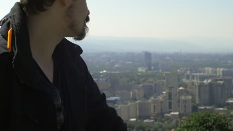 Closeup-male-half-face-slow-motion-city-view-point