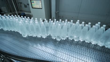 conveyor belt with bottles of drinking water at a modern beverage plant