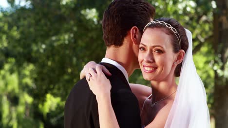 smiling bride embracing her new husband