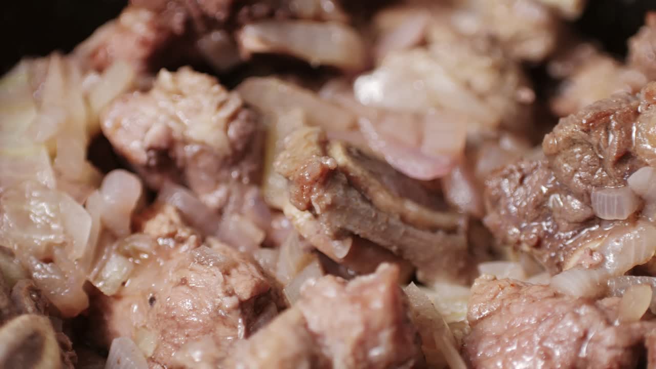 Chicken or pork stew with red and green pepper onion, and spices cooking in a frying pan. Traditional mexican cuisine, tacos preparation, ragout.