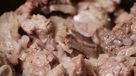 chicken or pork stew with red and green pepper onion, and spices cooking in a frying pan. traditional mexican cuisine, tacos preparation, ragout.