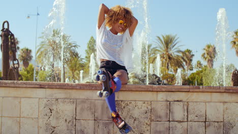 Happy-Sexy-Girl-Sitting-on-Fountains-Wall