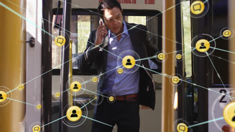 animation of network of connections with icons over asian businessman talking on smartphone