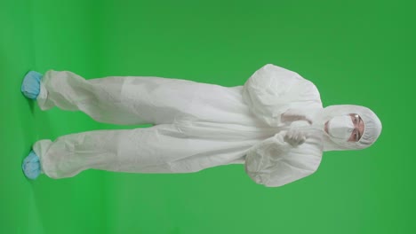 person in protective gear clapping on green screen