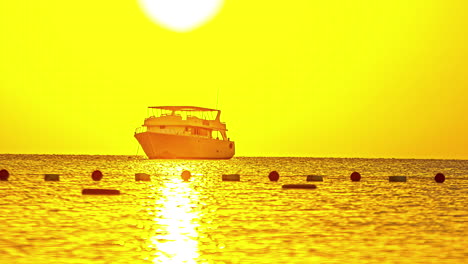 reflection of bright sunlight above a yacht moored at an anchor