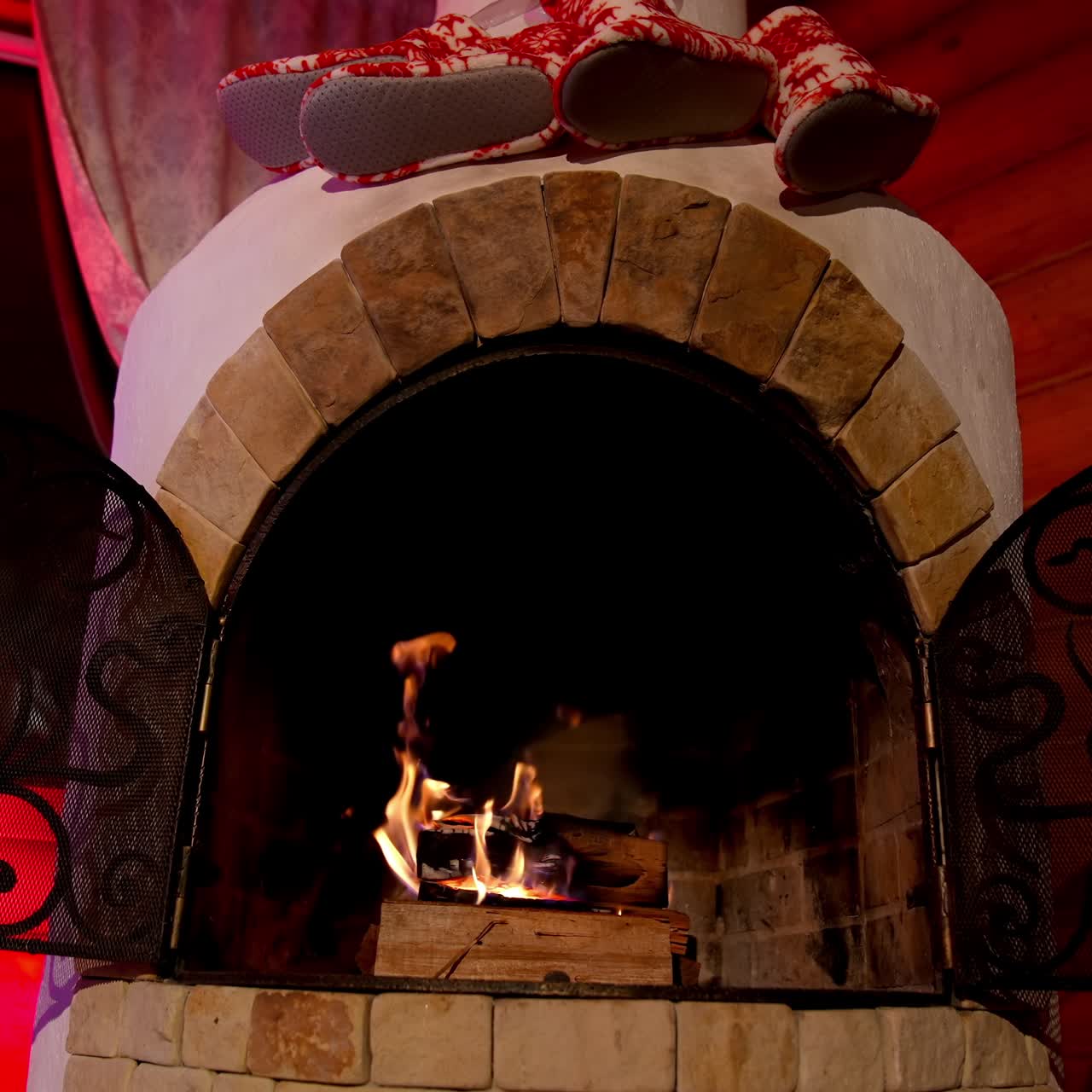Fireplace interior at home in Christmas time. Beautiful fireplace in country house. Background for the design of New Year's greetings. Warmth and comfort at home at winter holidays