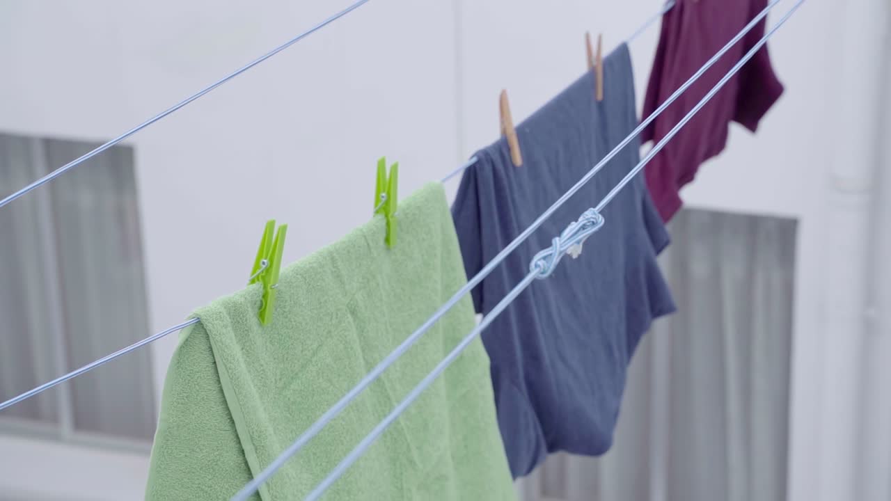 Closeup view of laundry hanged on ropes - PANNING BOTTON to TOP