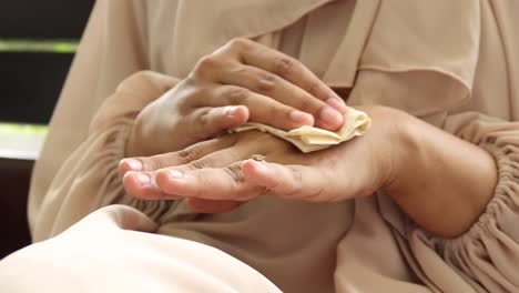 woman applying lotion or cream to her hands