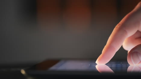 pantalla táctil de la tableta con el dedo tocando de cerca