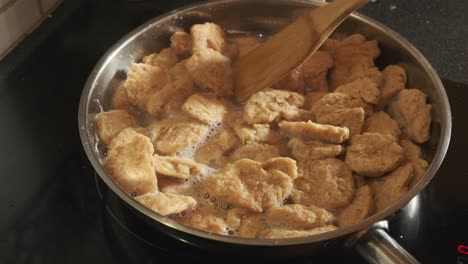 cooking vegan tvp textured vegetable protein in a pan, in slow motion 4k