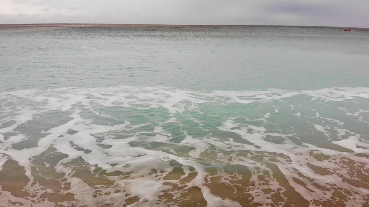 Kenting Baishawan beach turquoise water waves crashing on the beautiful sand, White Sand Bay, Hengchun Peninsula of Pingtung County, Taiwan. Drone dolly 4K shot.