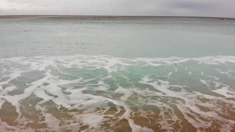 kenting baishawan beach turquoise water waves crashing on the beautiful sand, white sand bay, hengchun peninsula of pingtung county, taiwan. drone dolly 4k shot.
