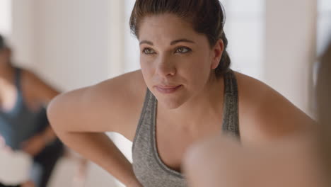 yoga class portrait young pregnant hispanic woman practicing poses holding belly enjoying group exercise in fitness studio