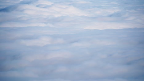 aerial time lapse of fog clouds over the mountains