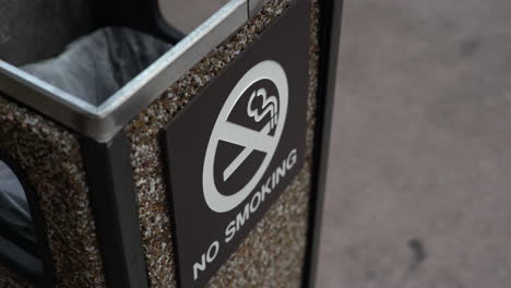 no smoking sign on a trash can