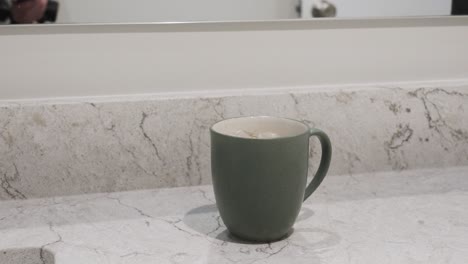 pushing in toward the mug on a counter