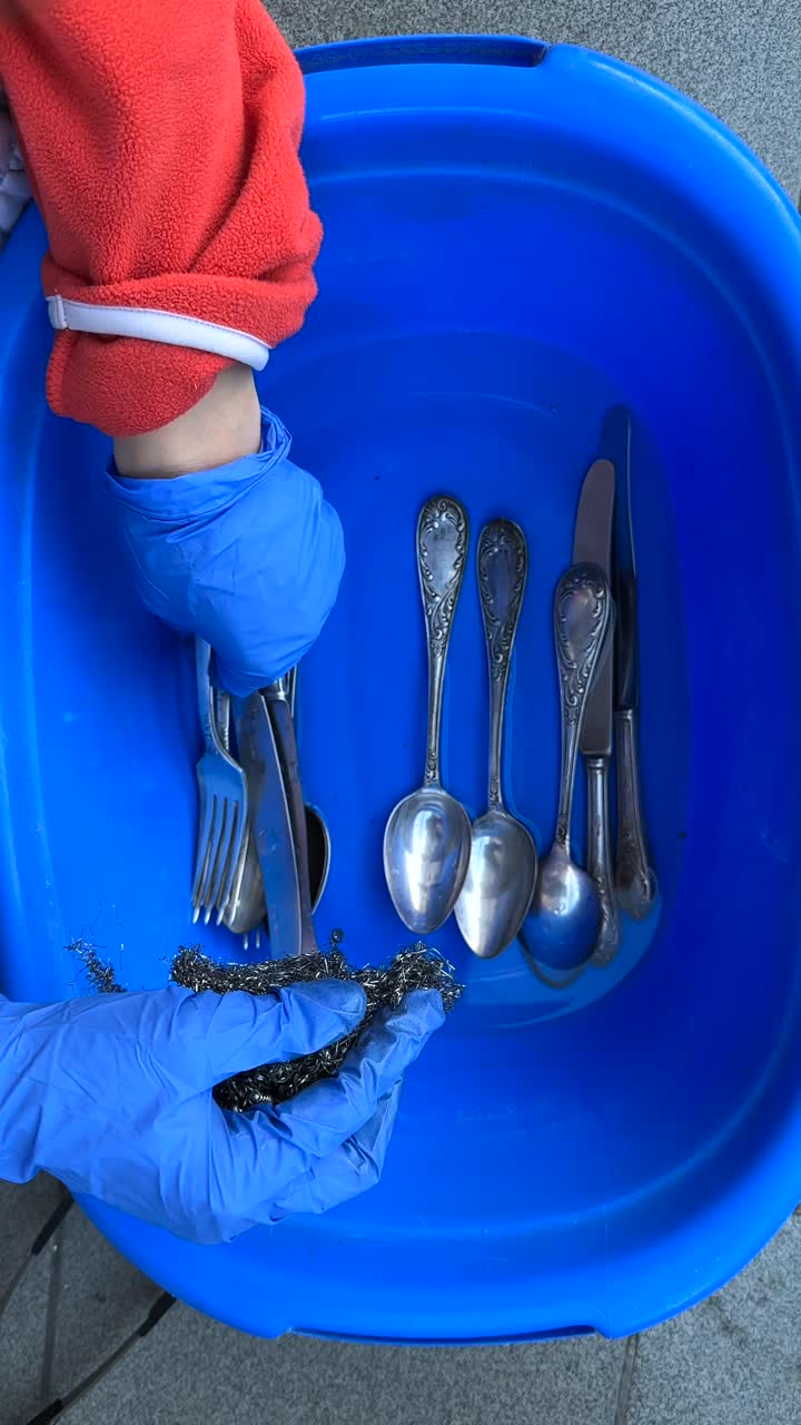Cleaning Silverware in a Plastic Basin