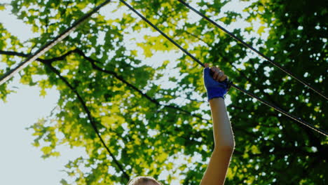 Active-Child-Fearlessly-Climbs-The-Ropes-Between-The-Trees