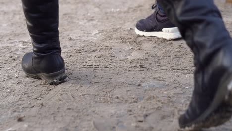 people walking on a muddy path in winter