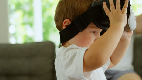 boy using virtual reality headset at home 4k