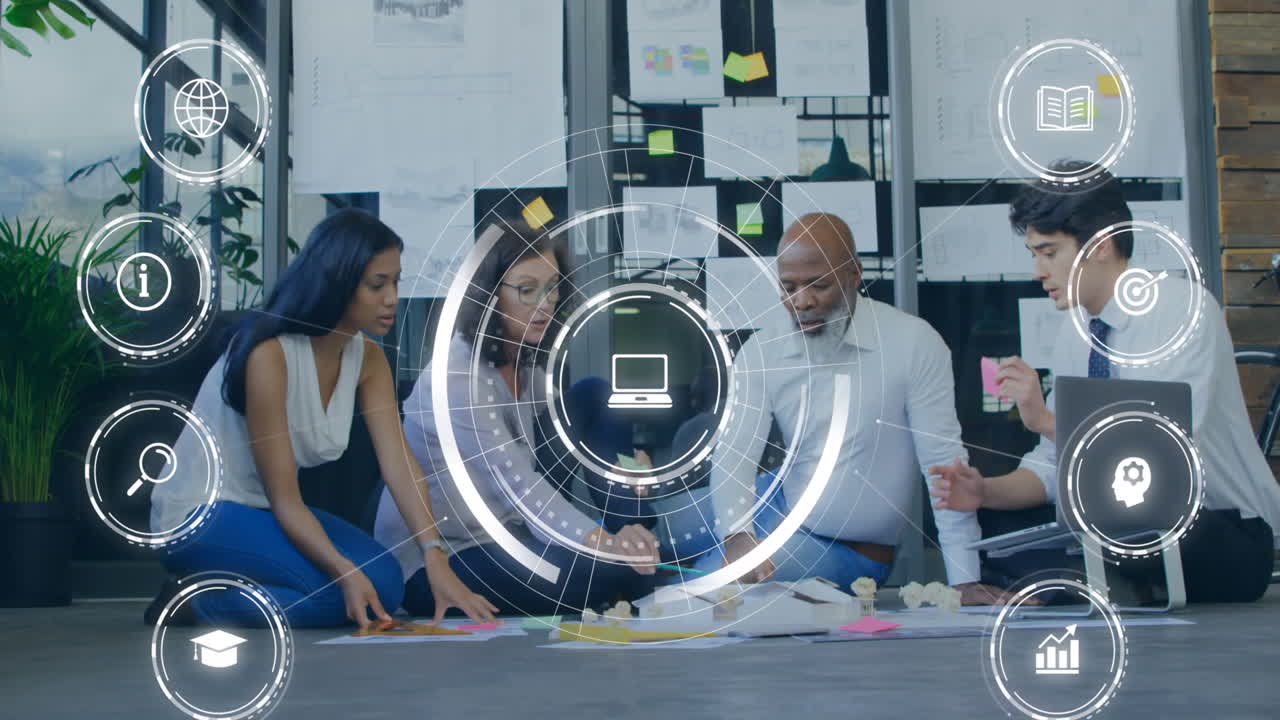 Animation of network of digital icons against diverse colleagues discussing over a plan at office