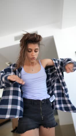 young woman dancing in a plaid shirt