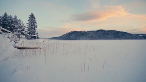 frozen field with mountain background in indre fosen, norway - wide